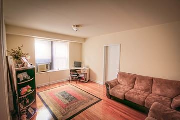 Orange apartment for rent - a living room with a couch and a tv