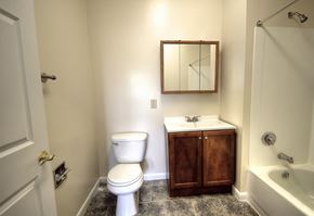 East Orange apartment for rent - Bathroom with wooden cabinets and grey patterned tile floors