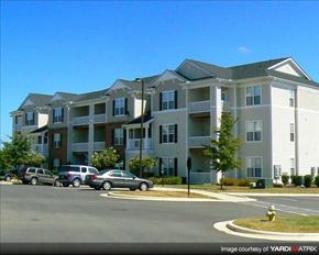 Garner apartment for rent - Apartment building with cars parked in front.