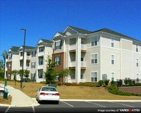 Garner apartment for rent - A white car is parked in front of a building.