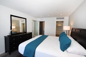 Marina Del Rey apartment for rent - a bedroom with a large bed and a mirror in a hotel room