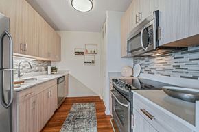 Chicago apartment for rent - Galley kitchen with light cabinets and stainless steel appliances at Kingsbury Plaza in River North Chicago at Kingsbury Plaza, Chicago, 60654