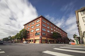 San Francisco apartment for rent - a large brick building on the corner of a city street