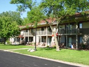 Middleton apartment for rent - an apartment building with green grass and trees