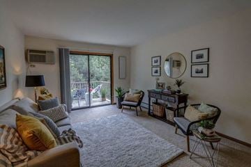 Middleton apartment for rent - a living room with a couch and a door to a balcony