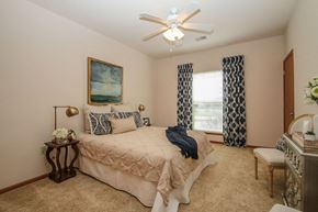 Sun Prairie apartment for rent - a bedroom with a bed and a ceiling fan