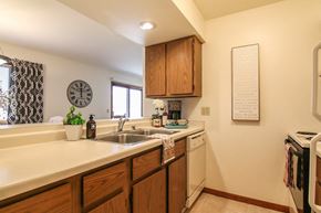 Madison apartment for rent - a kitchen with a sink and a dishwasher and a clock on the wall
