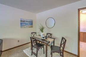 Maple Bluff apartment for rent - a dining room with a table and chairs and a round mirror