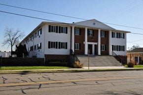 Maple Bluff apartment for rent - a large white building with steps in front of a street