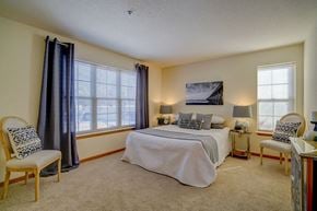 Sun Prairie apartment for rent - a bedroom with a bed and two windows
