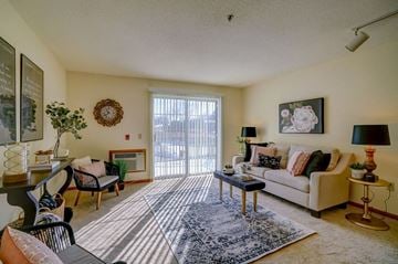 Sun Prairie apartment for rent - a living room with furniture and a sliding glass door