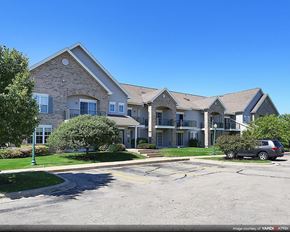 Sun Prairie apartment for rent - an apartment building with a car parked in front of it