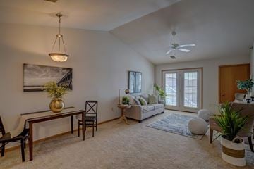 Sun Prairie apartment for rent - a living room with a couch and a desk and a ceiling fan