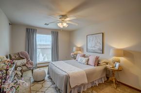 Sun Prairie apartment for rent - a bedroom with a bed and a ceiling fan