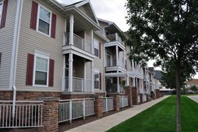 Sun Prairie apartment for rent - a row of houses with a sidewalk in front of them