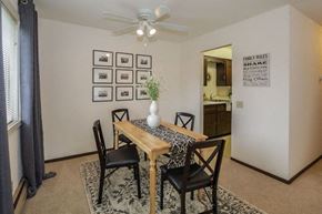 Fitchburg apartment for rent - a dining room with a table and chairs and a ceiling fan