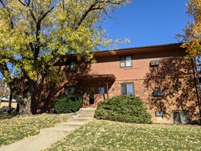 Fitchburg apartment for rent - a red brick building with stairs in front of a tree