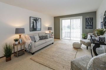 Fitchburg apartment for rent - a living room with a couch and a sliding glass door