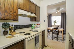 Fitchburg apartment for rent - a kitchen with a stove and a dining room with a table