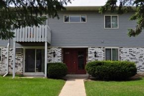 Verona apartment for rent - the front of a gray house with a red door