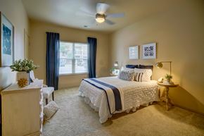 Sun Prairie apartment for rent - a bedroom with a bed and a ceiling fan