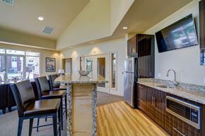 Sun Prairie apartment for rent - a kitchen with granite counter tops and a bar with chairs