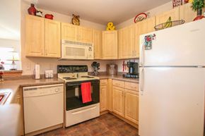 Madison apartment for rent - a kitchen with white appliances and wooden cabinets
