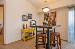 Madison apartment for rent - a dining room with a table and three stools