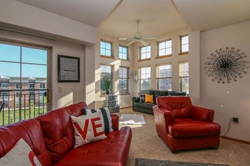 Madison apartment for rent - a living room with red leather furniture and large windows