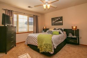 Madison apartment for rent - a bedroom with a bed and a ceiling fan