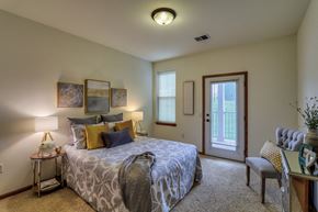 Madison apartment for rent - a bedroom with a bed and a door to a balcony