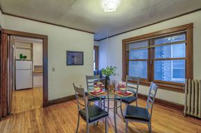 Madison apartment for rent - a dining room with a table and chairs and a large window