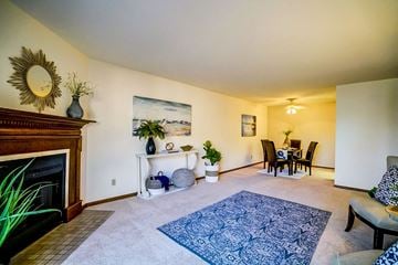 Middleton apartment for rent - a living room with a fireplace and a dining room table