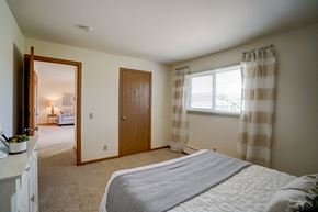 Fitchburg apartment for rent - a bedroom with a bed and a door and a window