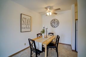 Fitchburg apartment for rent - a dining room with a table and a clock on the wall