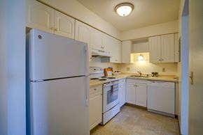 Fitchburg apartment for rent - a kitchen with white appliances and white cabinets