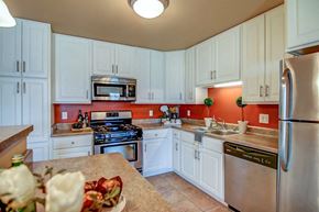 Madison apartment for rent - a kitchen with white cabinets and stainless steel appliances