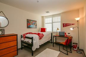 Madison apartment for rent - a bedroom with a bed and a desk and a window