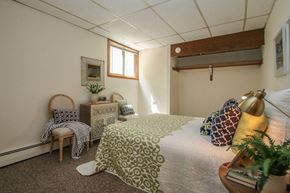 Madison apartment for rent - a bedroom with a bed and a chair and a window