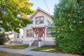 Madison triplex for rent - the front of a white house with a red door