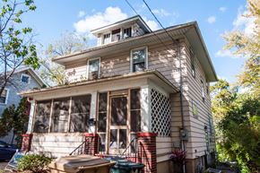 Madison triplex for rent - the front of a house with windows and a roof