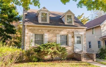Madison triplex for rent - a brick house with two windows on top of it