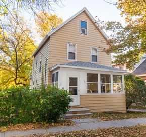 Madison triplex for rent - the front of a yellow house with a white door