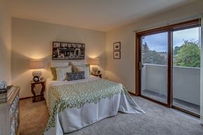 Madison apartment for rent - a bedroom with a bed and a sliding glass door