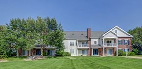 Fitchburg apartment for rent - a large lawn in front of a brick house