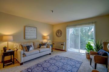 Deforest apartment for rent - a living room with a couch and a sliding glass door