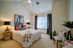 Madison apartment for rent - a bedroom with a bed and a ceiling fan