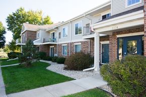 Madison apartment for rent - a view of the front of a building with a sidewalk and grass