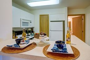 Madison apartment for rent - a kitchen with a table with plates and bottles of wine on it