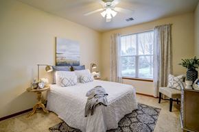 Madison apartment for rent - a bedroom with a bed and a ceiling fan